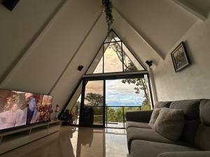 a living room with a large window and a couch at Casa Jardin BV in San Antonio