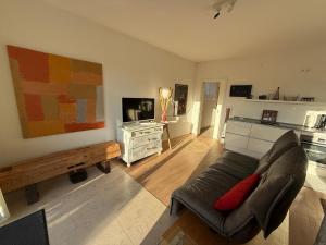 a living room with a couch and a table at Ferienwohnung Burgenblick mit Blick auf Riedenburg in Riedenburg +12 photos