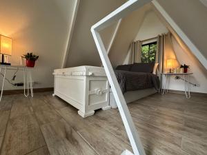 a room with a bed and a dresser in a attic at Casa Jardin BV in San Antonio