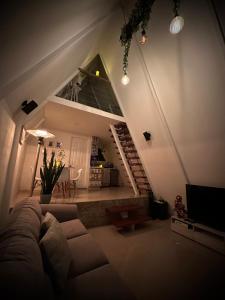 a living room with a couch and a staircase at Casa Jardin BV in San Antonio