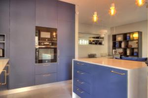 a kitchen with blue cabinets and a blue island at Mouzinho50 - Elegant Apartment in Póvoa de Varzim