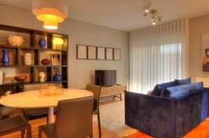 a living room with a table and a couch at Mouzinho50 - Elegant Apartment in Póvoa de Varzim