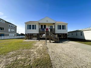 a large house with a porch and a house at KD1730 - Cole's Cabana in Kill Devil Hills