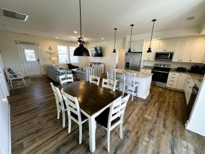 a kitchen and living room with a table and chairs at KD1730 - Cole's Cabana in Kill Devil Hills