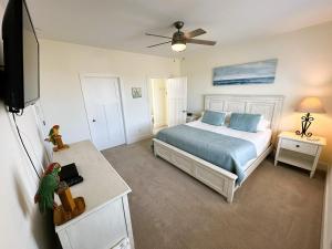 a bedroom with a bed and a flat screen tv at KD1730 - Cole's Cabana in Kill Devil Hills +9 photos
