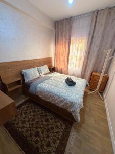 a small bedroom with a bed and a window at Julie Airport Boarding Apartment in Marrakesh