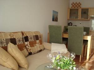 a living room with a couch and a table at Küstenliebe in Kirchdorf +3 photos
