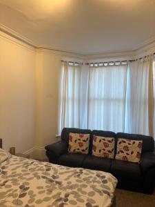 a living room with a couch and a window at Palace in Crystal Palace