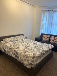 a bedroom with a bed and a couch at Palace in Crystal Palace