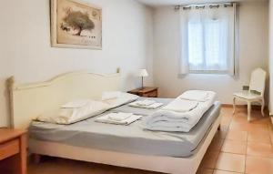a bedroom with a bed with towels on it at Maison 1 in Montauroux