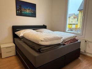 a unmade bed in a bedroom with a window at Gemütliche Unterkunft Sankt Blasien in St. Blasien
