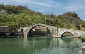 a stone bridge over a river in a mountain at Casa Sant'anna in Stazzema