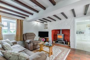 a living room with a couch and a fireplace at 2 Bed in Yatton oc-s32603 in Leinthall Earls