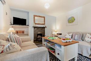 a living room with a couch and a table at 2 Bed in Wadebridge oc-r27444 in Little Petherick