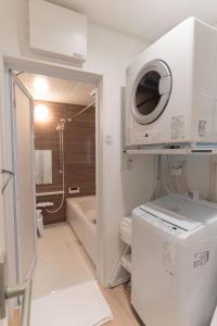 a bathroom with a sink and a washing machine at Naha Airport NewVilla 4 bedrooms, 2 modern bathrooms, 3 FREE parking in Itoman +76 photos