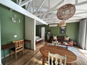 a living room with a table and a couch at Meander Stay Clarens in Clarens