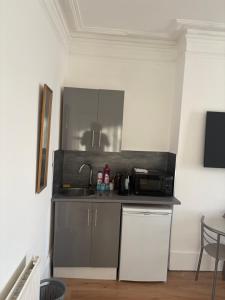 a small kitchen with a sink and a microwave at Crystal in Crystal Palace