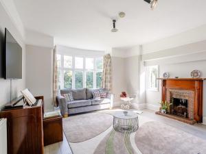 a living room with a couch and a fireplace at 4 Bed in Mablethorpe oc-77958 in Sutton on Sea