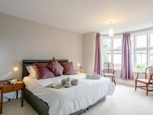 a bedroom with a large bed with two stuffed animals on it at 4 Bed in Mablethorpe oc-77958 in Sutton on Sea