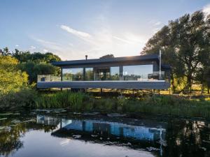 a glass house with a view of a pond at 2 Bed in Richmond oc-95005 in Gilling