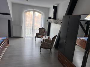 a bedroom with two chairs and a table and a bed at Agroturystyka Maya in Gorzyca