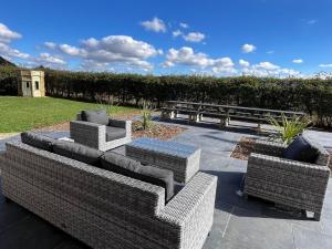 a group of couches sitting on a patio at 9 Bed in Ipswich oc-62352 in Freston
