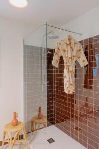 a robe hanging in a shower in a bathroom at Masia Can Pares in Sant Pere de Ribes +32 photos