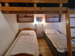two beds in a room with two bunk beds at Haus Austernfischer in Schweiburg