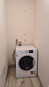 a washing machine in a corner of a room at Haus Lüchtje Jade in Sehestedt