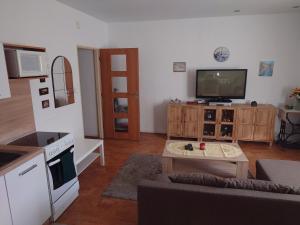 a living room with a couch and a table at Zukalka 2KK - 1 in Ostrava