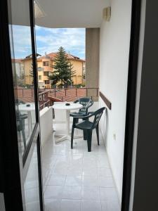 a view of a balcony with a table and chairs at kaLe in Ravda