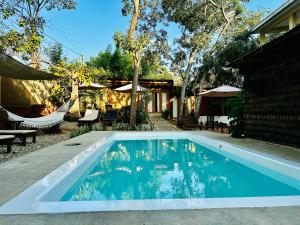 a swimming pool in front of a house at Suites Costa Madéro - Punta Zicatela in Brisas de Zicatela
