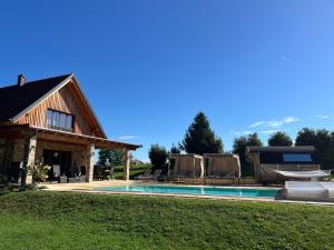a house with a swimming pool and some chairs at Landvilla Sinelia premium in Dietersdorf am Gnasbach