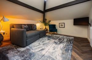a living room with a couch and a television at The Coach and Horses in Clitheroe