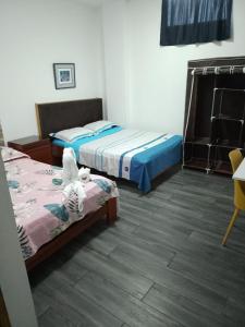 two beds in a room with two beds sidx sidx sidx at Hotel Ruah in Tumbes