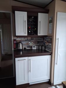 a kitchen with white cabinets and a counter top at St Nicholas Number 5 in Turnberry +3 photos