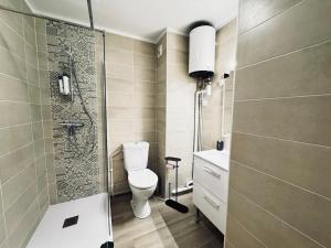 a bathroom with a toilet and a sink and a shower at Sète Studio Parking Privé Loggia in Sète
