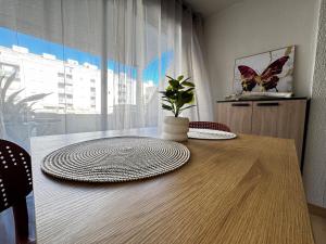 a dining room table with plates and a plant on it at Sète Studio Parking Privé Loggia in Sète