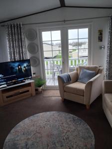 a living room with a couch and a television at St Nicholas Number 5 in Turnberry