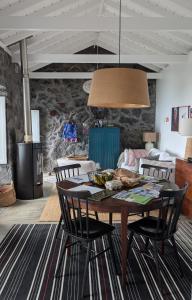 a dining room with a table and some chairs at Casas do Horizonte in Ribeiras