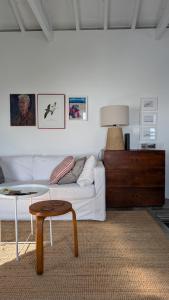 a living room with a white couch and a table at Casas do Horizonte in Ribeiras