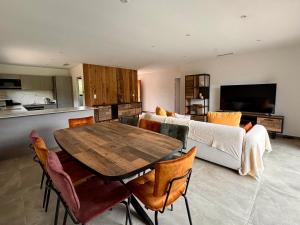 a living room with a table and a couch at Villa Sébastien by Intendance Excellency in Zonza