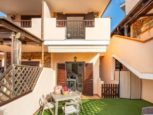 a view of the courtyard of a house with a table and chairs at Estay - Maria's Wonderful Retreat in Villasimius