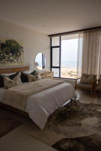 a bedroom with a large bed and a large window at Oceana View at Oceans 3 Selfcatering Holiday Home in Rand Rifles +65 photos