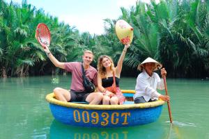 a group of people sitting in a boat in the water at Muoi Villa in Hiếu Nhơn +26 photos