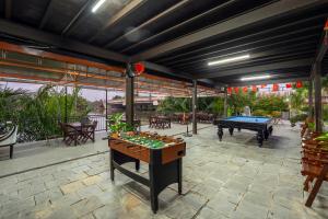 a patio with a ping pong table and a pool table at Muoi Villa in Hiếu Nhơn