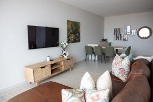 a living room with a couch and a tv at Oceana View at Oceans 3 Selfcatering Holiday Home in Rand Rifles
