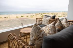 a living room with a couch and a view of the beach at Oceana View at Oceans 3 Selfcatering Holiday Home in Rand Rifles