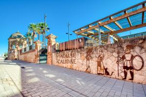 a wall with a mural of a tennis player on it at Pati Blau 2 in Caldes de Malavella