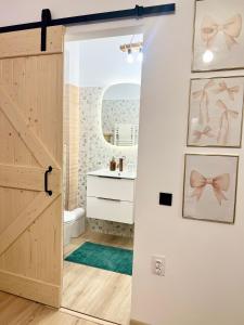 a bathroom with a wooden door and a sink at Summer Studio in Constanţa +71 photos